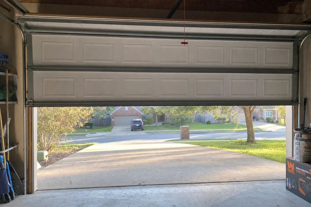 View from inside a garage through a newly installed door — post-job photo in Keller TX