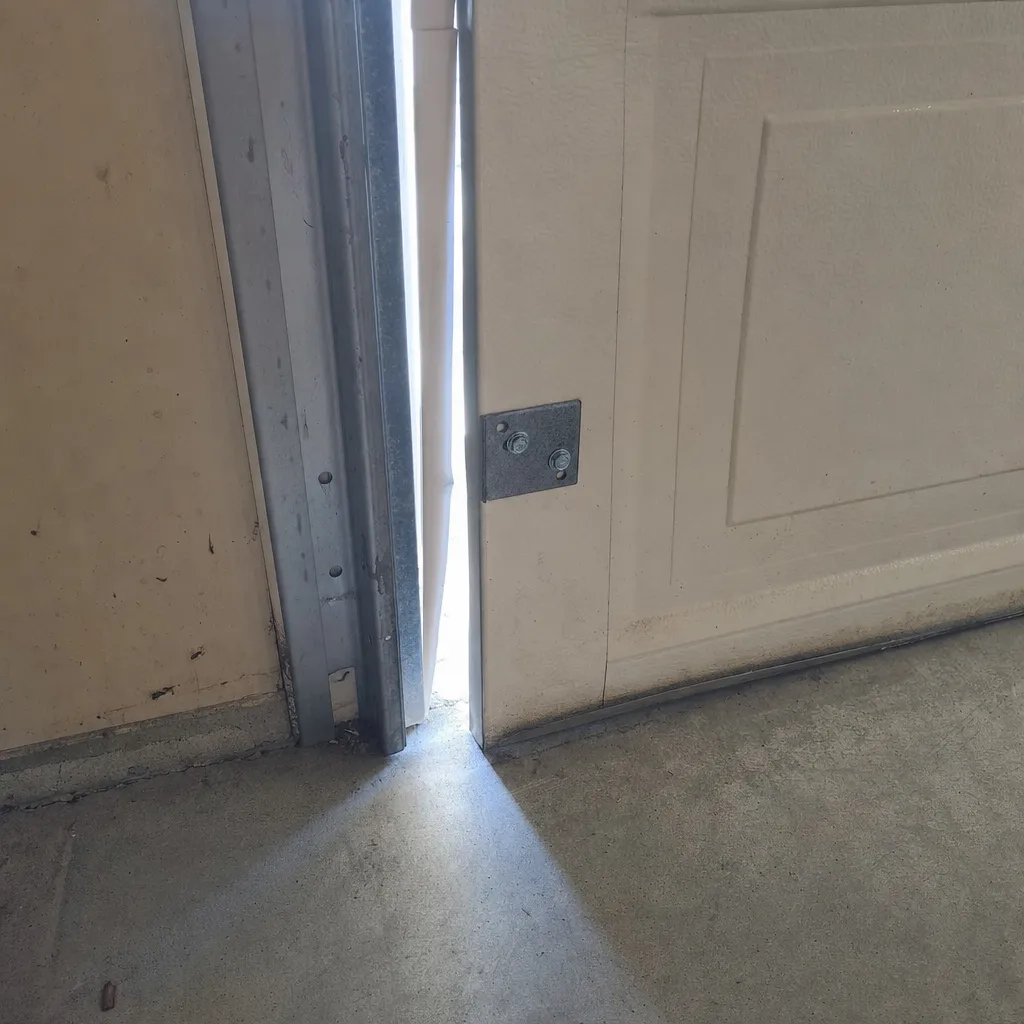 Garage door off its track — documented from inside before realignment repair in Southlake TX