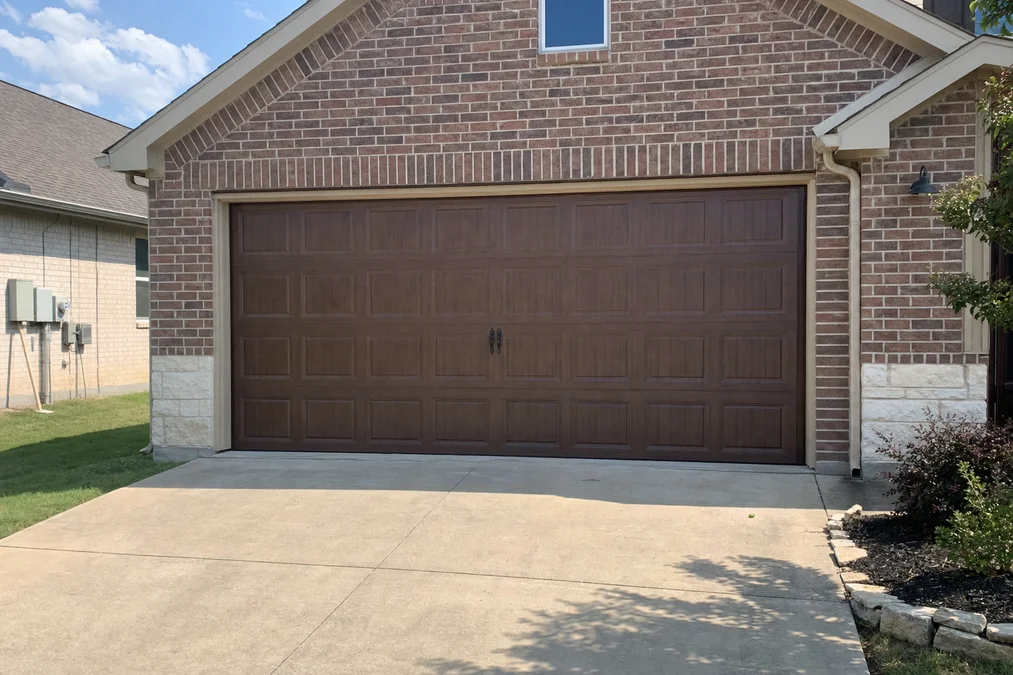 Garage door on a brick home in Southlake TX — photographed before a same-day repair job